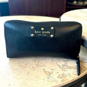 Large Black Kate Spade zippered wallet with gold accents.